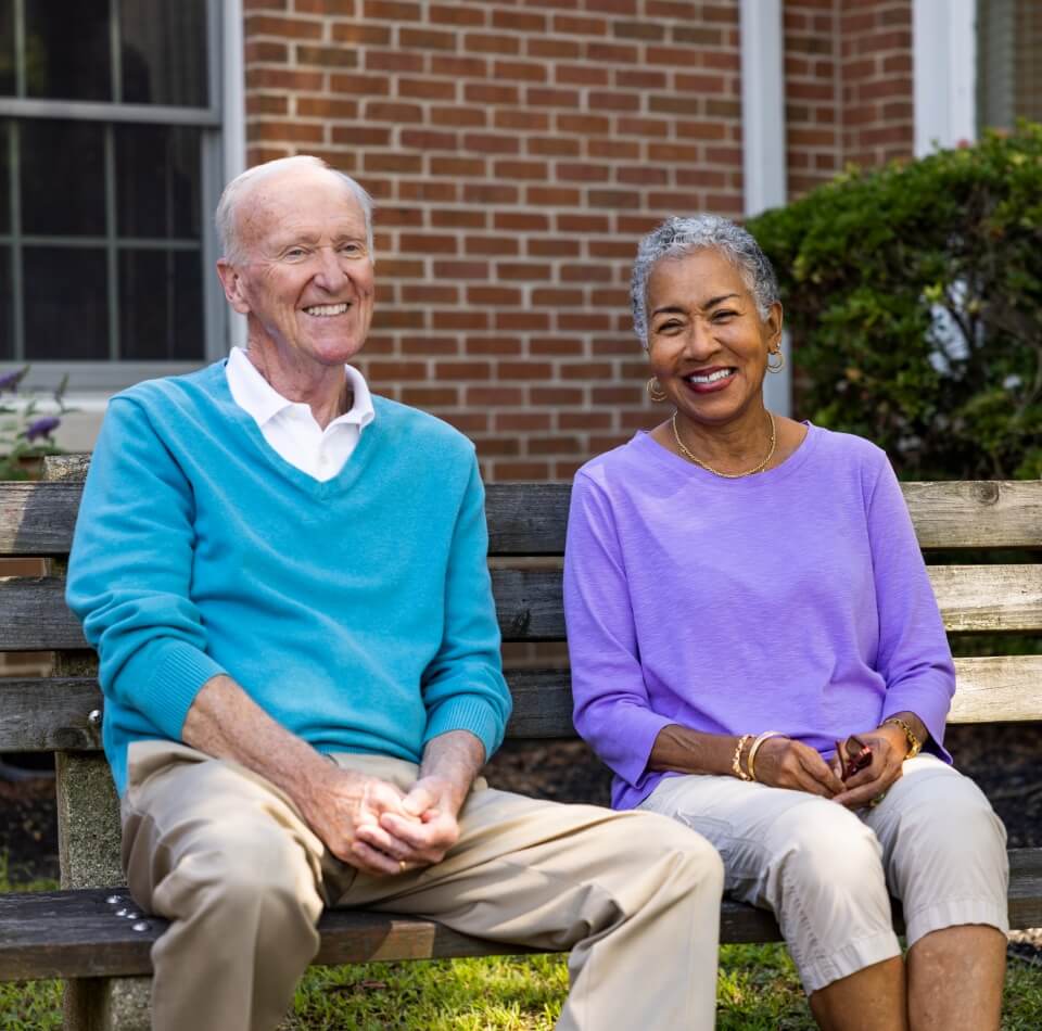 two Millcroft residents sitting on a park bench