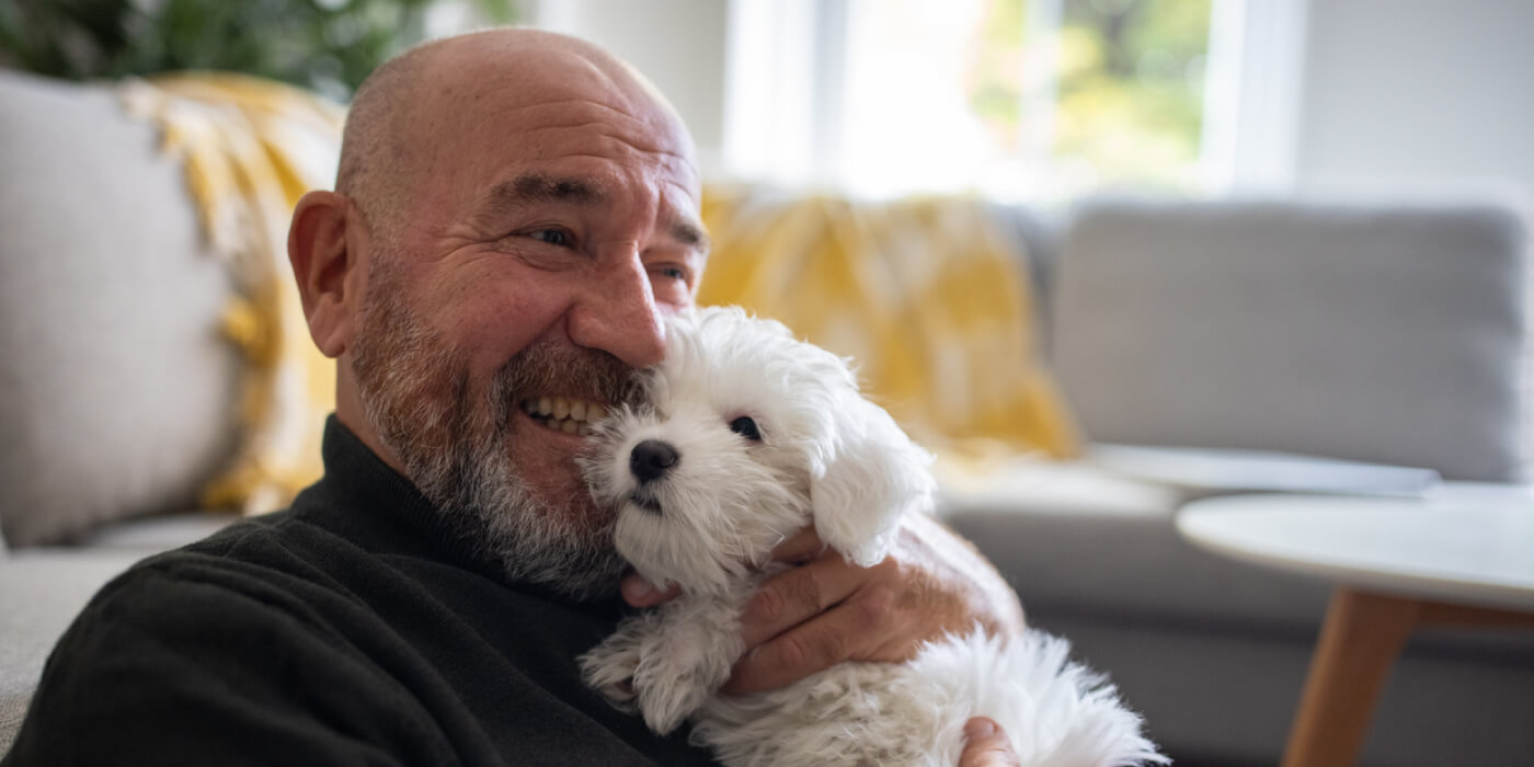 Senior man holding dog
